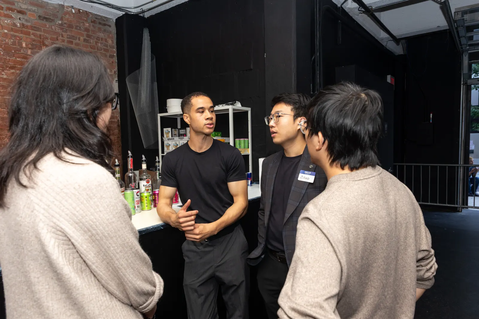 Three guests talk together between sessions at Future of NYC Design.