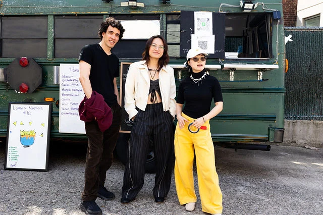 Three High Society collaborators pose together beside a food truck.