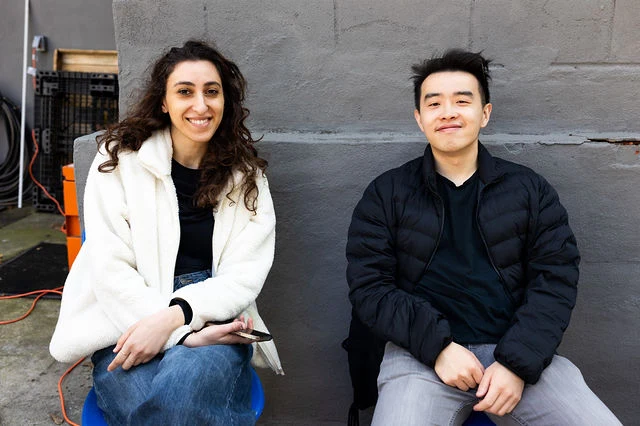 Two guests sit together outside during High Society.