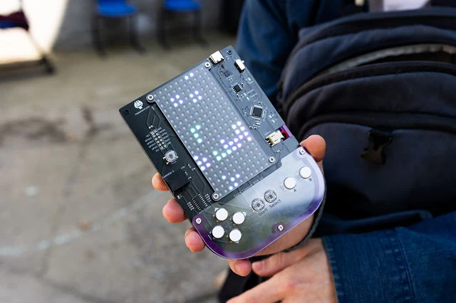 A guest holds an interactive handheld device at High Society.