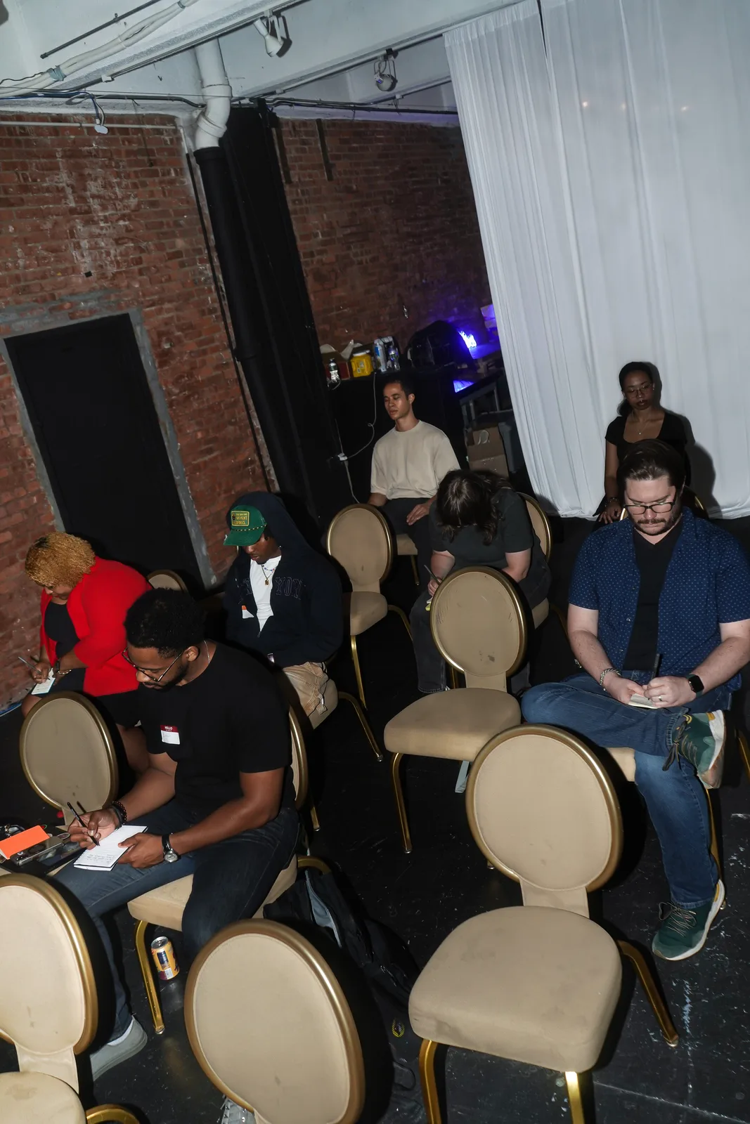Guests gather around the presentation space during Out of Office: Pride.