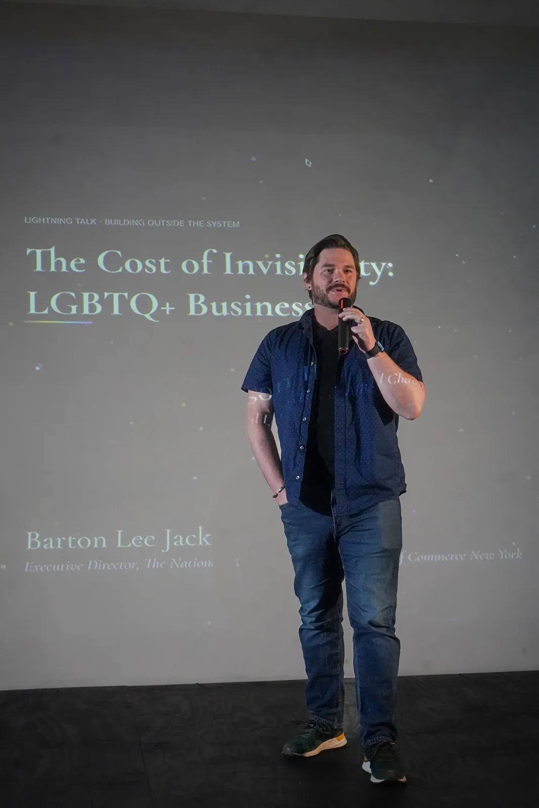A presenter delivers a lightning talk on the Out of Office stage.
